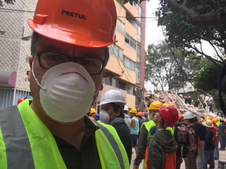 Patricio working with his fellow countrymen to remove debris in the hope of finding people trapped in the rubble
